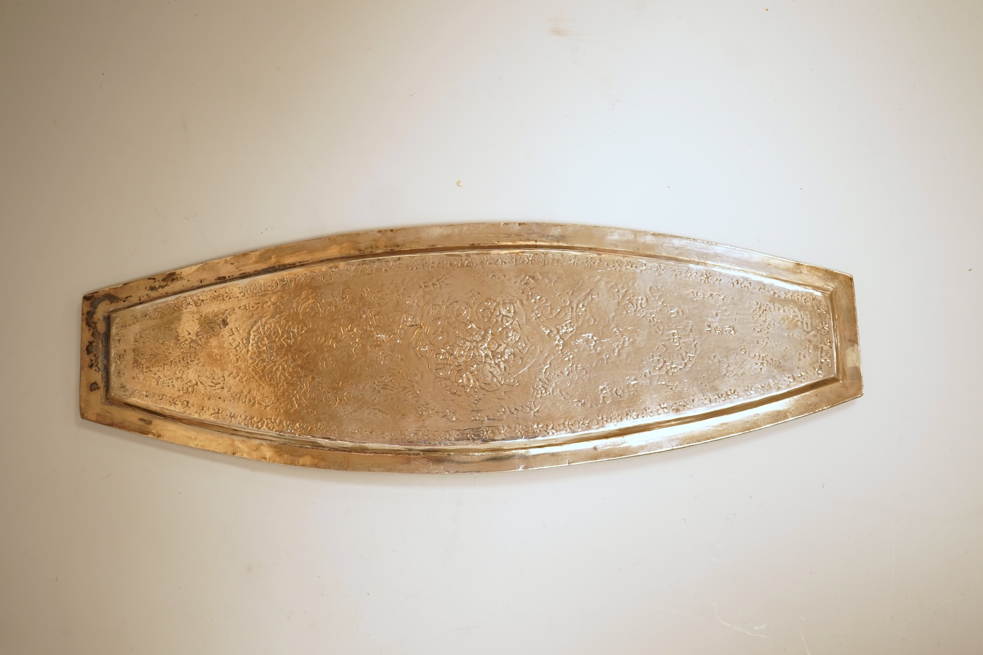 A set of six 20th century Middle Eastern white metal tots, 42mm and matching tray, 25.2cm, all engraved with geometric foliate decoration.